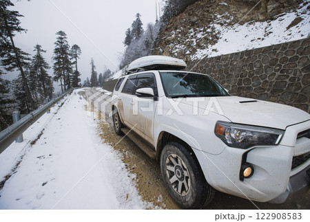 Driving White 2020 Toyota 4Runner TRD crossing in the snowing mountain trail, Tibet, China Driving White 2020 Toyota 4Runner TRD crossing in the snowing mountain trail, Tibet, China 122908583