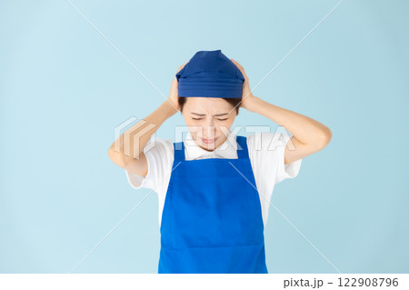 女性　エプロン　パート　アルバイト　頭を抱える 122908796
