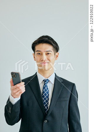 スマホを持つ20代の若い男性 122910022
