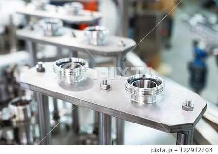Close-up of mechanical pneumatic equipment elements in manufacturing equipment production Close-up of mechanical pneumatic equipment elements in manufacturing equipment production 122912203