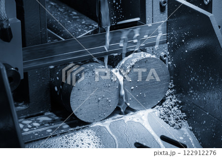 The band saw cutting machine cutting the metal shaft parts with coolant method. The band saw cutting machine cutting the metal shaft parts with coolant method. 122912276