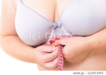 Woman plus size measuring her chest under breasts Woman plus size measuring her chest under breasts 122912943