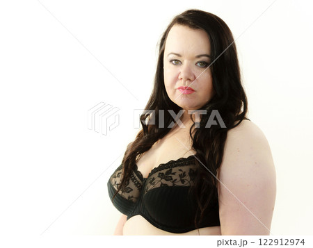 Woman in black bra showing her breast chest. 122912974