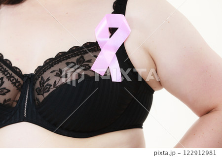 Woman chest in bra, pink cancer ribbon 122912981