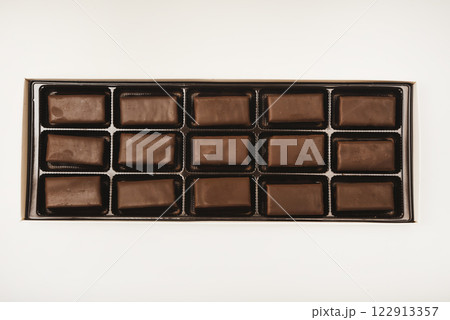 Chocolates in a box. A set of candies with white filling. 122913357