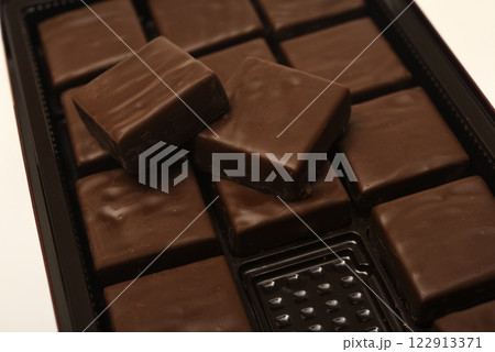 Chocolates in a box. A set of candies with white filling. Chocolates in a box. A set of candies with white filling. 122913371