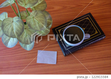 Still life,Old books with coffee cup and shot note on wood table. 122913384