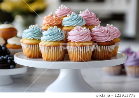Colorful cupcakes with frosting and pearls sitting on white cake stand Colorful cupcakes with frosting and pearls sitting on white cake stand 122913778