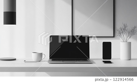 A laptop is on a desk with a cup of coffee and a vase of flowers. The laptop is turned off, and the desk is clean and organized. Concept of productivity and focus 122914566