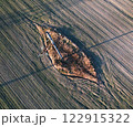 An aerial view shows a significant hole in a field 122915322