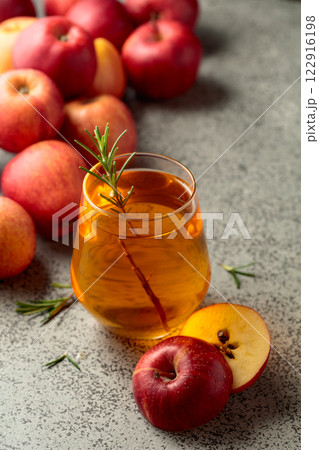 Apple juice and fresh apples on a kitchen table. 122916198