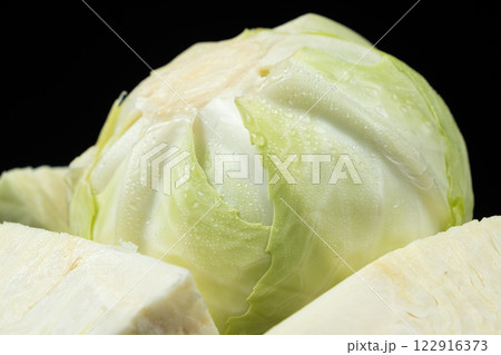 Whole heads of fresh white cabbage on a black background close-up. 122916373
