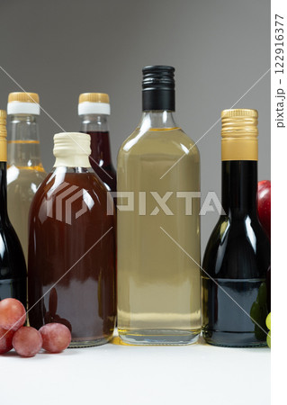 Different types of vinegar, apple, balsamic, wine and pomegranate vinegars in bottles Different types of vinegar, apple, balsamic, wine and pomegranate vinegars in bottles 122916377
