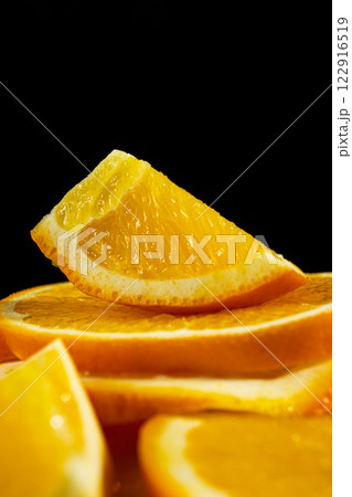 Orange background, ripe oranges cut into slices close-up. Orange background, ripe oranges cut into slices close-up. 122916519