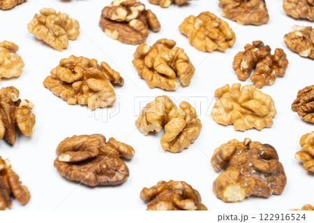 Shelled walnuts on a white background close-up Shelled walnuts on a white background close-up 122916524