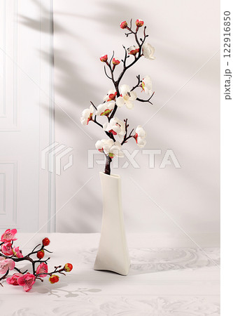 Abstract spring flower arrangement with cherry blossom branches in vase,elegant beauty concept,stage for product display and business concept.Minimal modern aesthetics 122916850