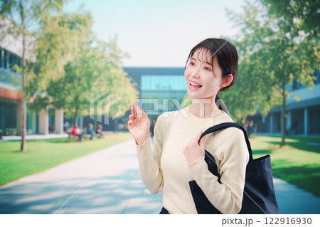 大学のキャンパスで過ごす若い女性 122916930