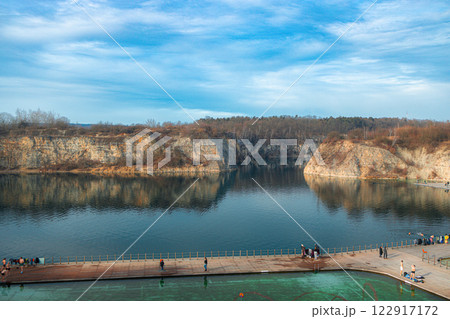 Swimming, paddling pools, sunbathing platforms on Zakrzowek lake with steep cliffs in place of former flooded limestone quarry. New public recreational place. Aerial view 122917172