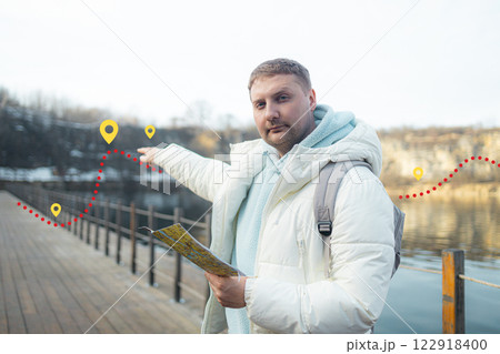 Male hiker reading map hiking trip looking to find place to go. Search, map and man lost in forest with guide to camp in woods or thinking of navigation or direction. Male hiker reading map hiking trip looking to find place to go. Search, map and man lost in forest with guide to camp in woods or thinking of navigation or direction. 122918400