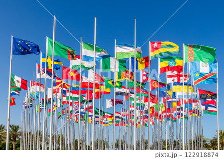 Many world's countries national flags waving on the wind, with European Union, Zambian, Sierra Lione, Uzbek, Turkmen, Togo, Ethiopian banners in the foreground, Doha, Qatar 122918874
