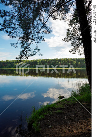 beautiful lake with cloud reflection surrounded by forest beautiful lake with cloud reflection surrounded by forest 122919449