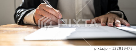 Businessman or a lawyer signing contract, report or legal document Businessman or a lawyer signing contract, report or legal document 122919475