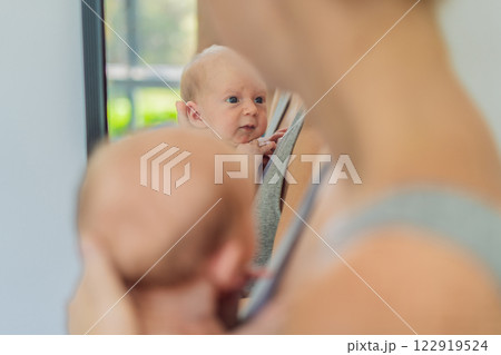 A mother lovingly embraces her newborn baby, holding them close to her chest. A tender moment of warmth, security, and deep maternal love, symbolizing bonding, comfort, and the unbreakable connection A mother lovingly embraces her newborn baby, holding them close to her chest. A tender moment of warmth, security, and deep maternal love, symbolizing bonding, comfort, and the unbreakable connection 122919524