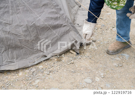 【中津川河川敷でオートキャンプ　テントスカート部分のペグを抜き撤収準備】 122919716