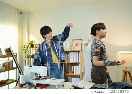 Creative fashion designers collaborating in a stylish workspace Creative fashion designers collaborating in a stylish workspace 122920579