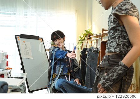 Young fashion entrepreneurs working on a denim project in a bright fashion studio 122920600