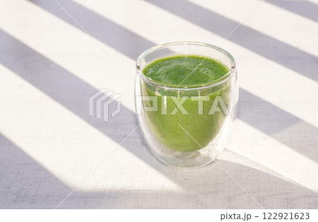 A cup of fresh green smoothie. Healthy food. A cup of fresh green smoothie. Healthy food. 122921623