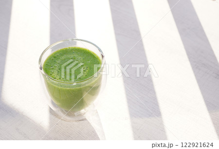 A cup of fresh green smoothie. Healthy food. A cup of fresh green smoothie. Healthy food. 122921624