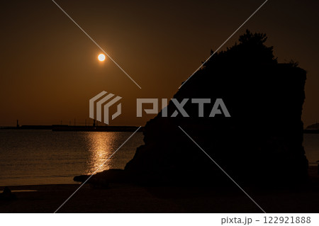 島根県の出雲市にある稲佐の浜の弁天島に沈む夕日の風景 島根県の出雲市にある稲佐の浜の弁天島に沈む夕日の風景 122921888