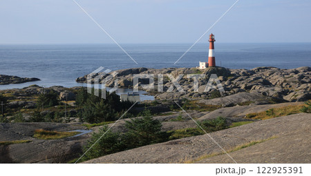 Eigeroy lighthouse, rock formations and ocean, Norway. 122925391