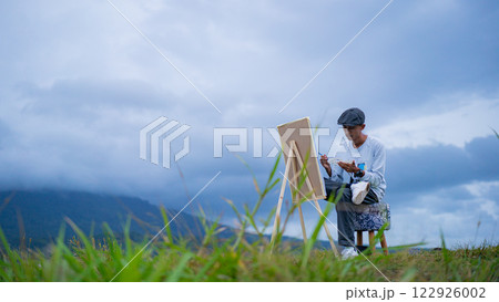 Outdoor Painting, Young Artist Capturing Mountain Views on Canvas under Cloudy Skies Outdoor Painting, Young Artist Capturing Mountain Views on Canvas under Cloudy Skies 122926002