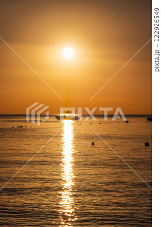 Beautiful red and orange sunrise over the sea. Beautiful red and orange sunrise over the sea. 122926549
