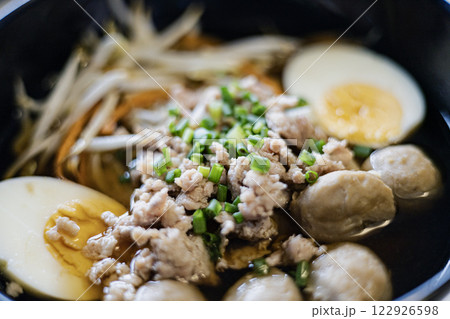 Bowl of Japanese noodle soup with pork, eggs and meatball isolated on white background 122926598