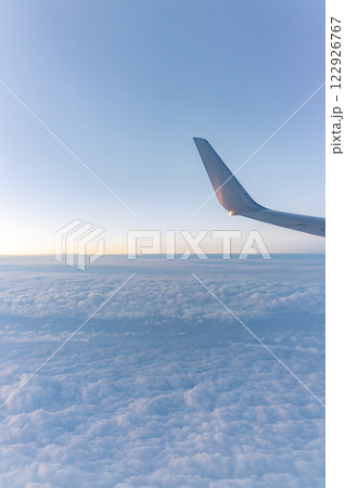 Beautiful salmon dawn and the wing of an airplane above the clouds. Beautiful salmon dawn and the wing of an airplane above the clouds. 122926767