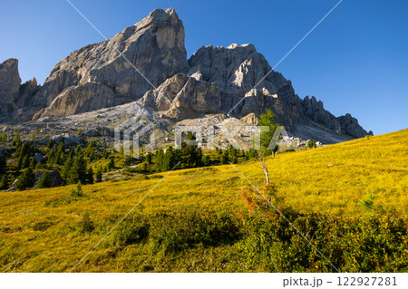 Mountain peak of Mont-de-Fornel, Dolomites stands majestically between sky and hilly valley 122927281