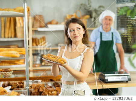 Young woman buyer with bocadillo in bakery Young woman buyer with bocadillo in bakery 122927362