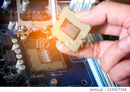 Hand of computer engineering brings computer cpu processor memory change components into socket processor for maintenance.Technology and development concept Hand of computer engineering brings computer cpu processor memory change components into socket processor for maintenance.Technology and development concept 122927368
