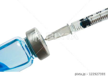 doctor's hand holds a syringe and a blue vaccine bottle at the hospital. Health and medical concepts. doctor's hand holds a syringe and a blue vaccine bottle at the hospital. Health and medical concepts. 122927393