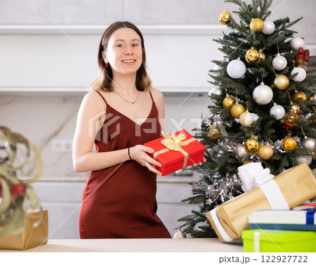 Cheerful woman poses against the background of a Christmas tree 122927722