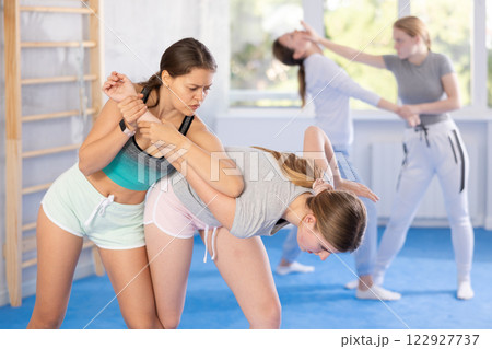Pair self defense training - two teenage girls doing power grabs Pair self defense training - two teenage girls doing power grabs 122927737