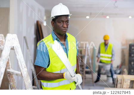 Repairman working in construction site in apartment Repairman working in construction site in apartment 122927845