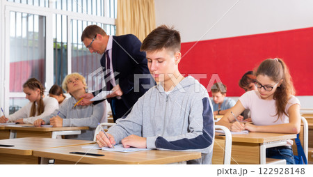 Teenage students working at class during lesson 122928148