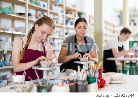 Teenagers are interested in making dishes from clay in pottery workshop 122928244