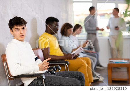 Indignant guy waiting for clerk consultation in lobby of government agency 122928310