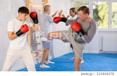 Portrait of defferent ages active sportsmen competing in boxing gloves Portrait of defferent ages active sportsmen competing in boxing gloves 122928378