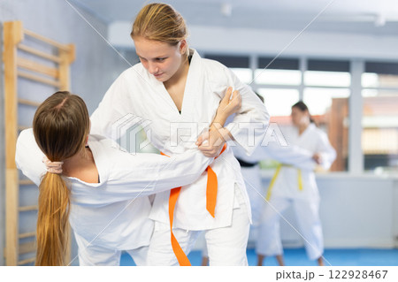 Females in kimono practicing fighting moves Females in kimono practicing fighting moves 122928467